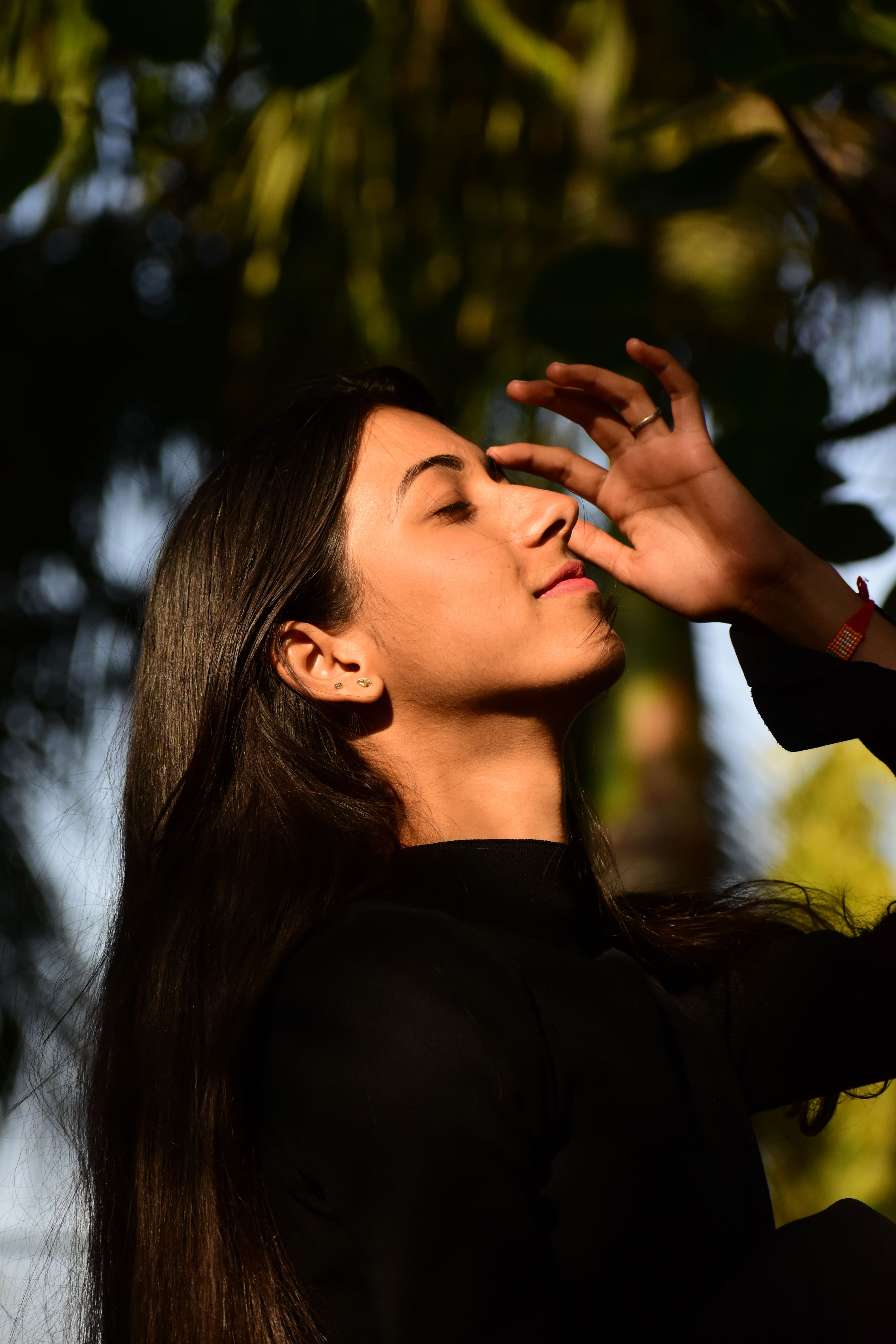 Indian woman feeling the warmth of winter sunlight on her face